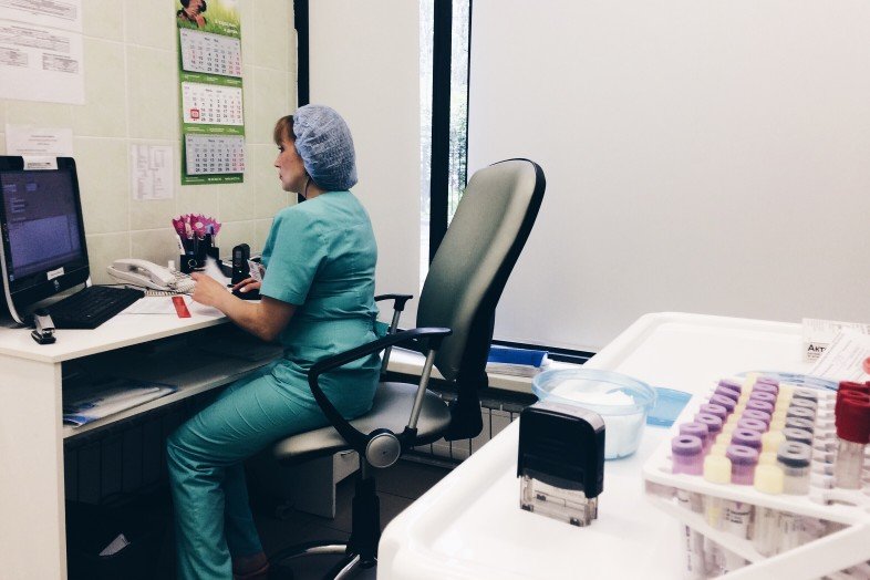 clinic nurse working on computer desk